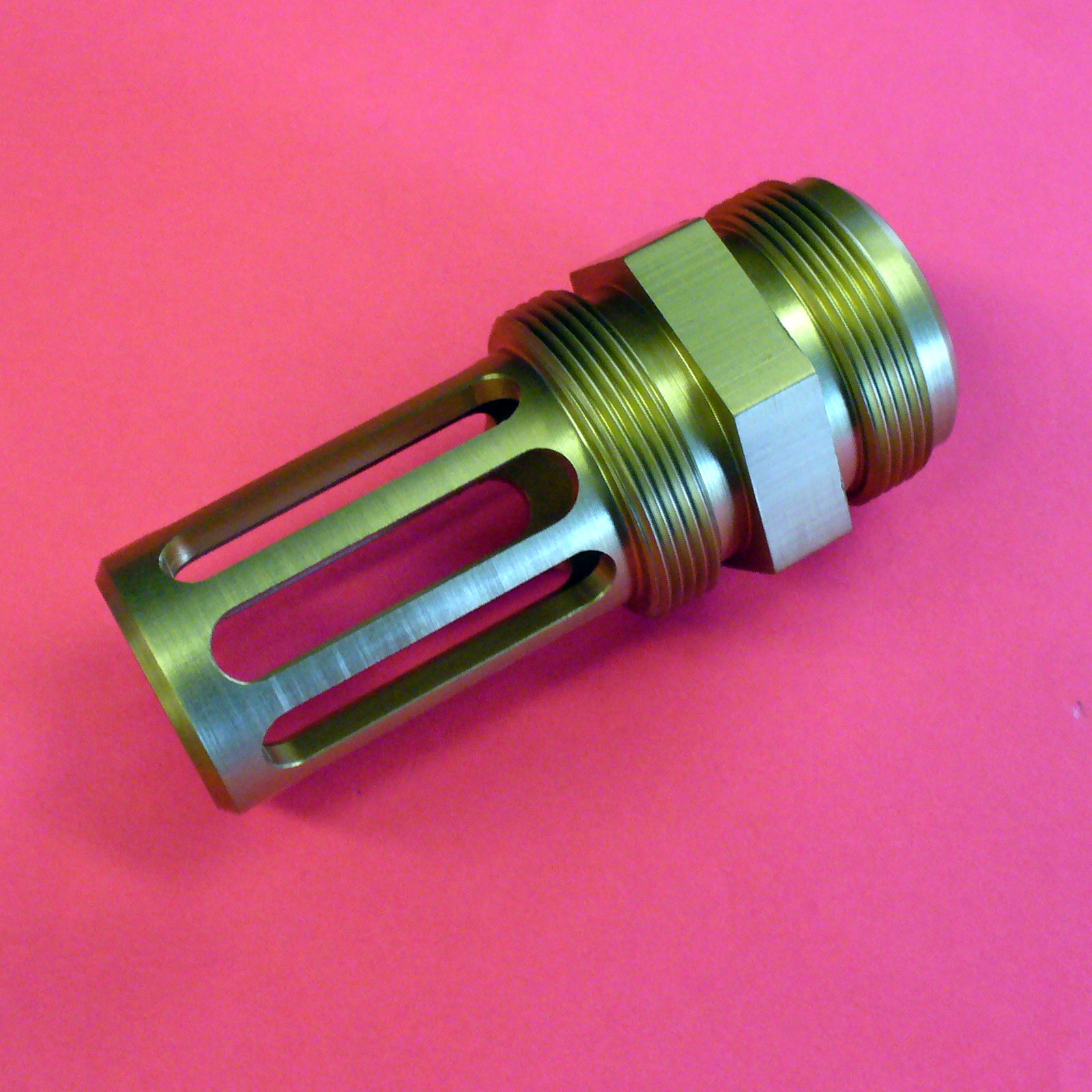 Metallic cylindrical object on a pink background