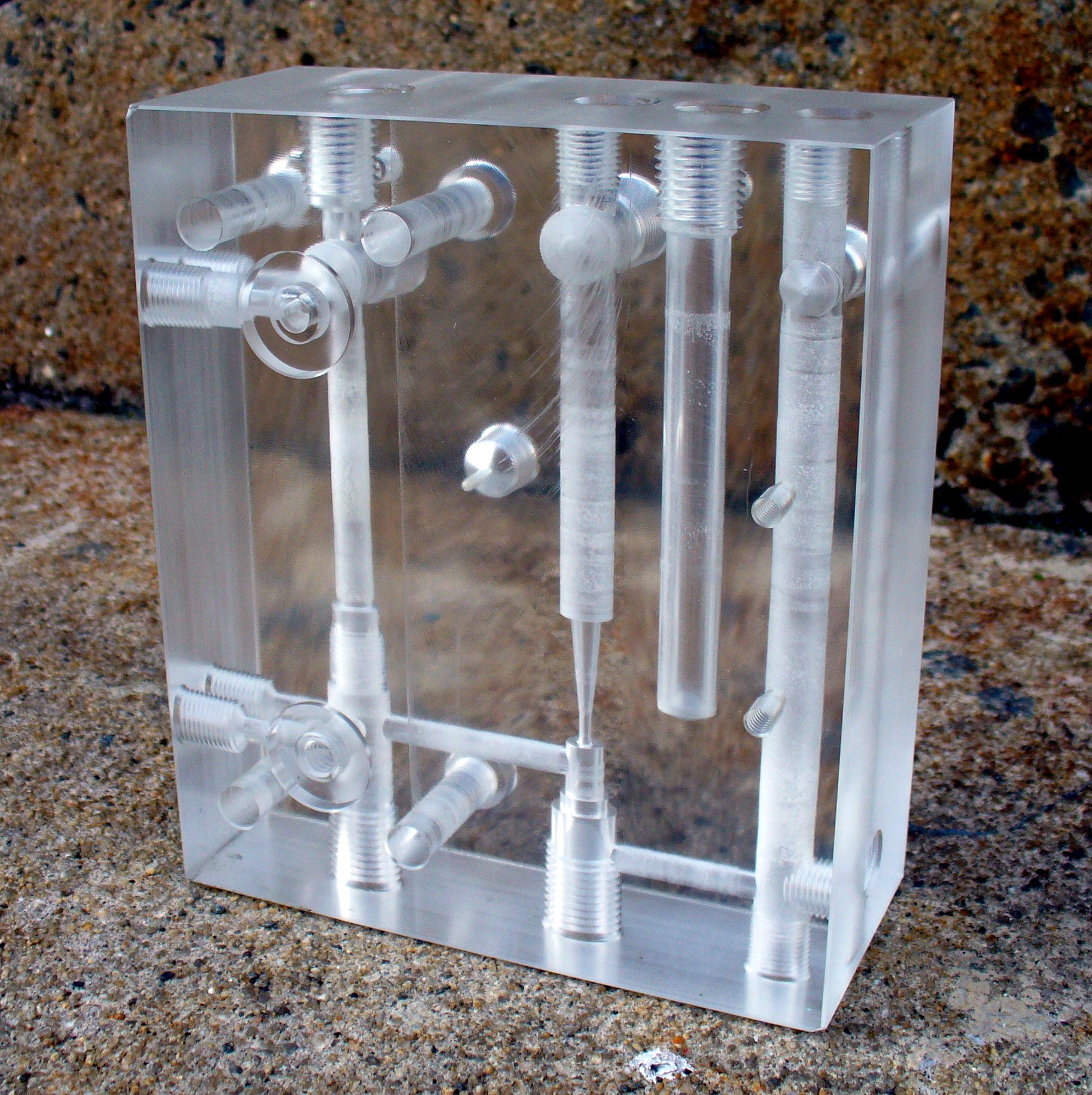 Clear acrylic model of a chemical reaction apparatus on a textured surface